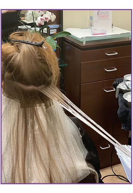 Professional colorist applying hair color in the Las Vegas salon